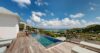 Luxury St Barts villa at sunset with glowing infinity pool and panoramic Caribbean views.
