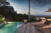 Private infinity pool at a St Barts villa with wooden deck, sun loungers, and ocean views at dusk.