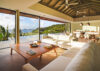 Spacious open-plan living room in a St Barts villa with white sofas, vaulted ceiling, and panoramic ocean views.
