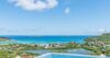 Infinity pool with sweeping views of turquoise waters and lush hillsides at a luxury St Barts villa rental.
