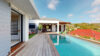 Wooden deck with swimming pool leading to a shaded outdoor dining terrace at a private St Barts villa rental.