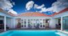 Private courtyard pool framed by white shutters and red rooftops at a luxury St Barts villa rental.