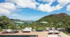 Sun loungers on a wooden deck with hillside and ocean views at a private St Barts villa rental.