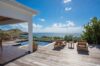 Spacious wooden terrace with sun loungers and pool overlooking the Caribbean Sea at a St Barts villa rental.