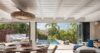 Open-plan dining area with poolside view and tropical greenery at a luxury St Barts villa.