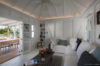 Elegant living room at a St Barts villa rental with plush seating and ocean views through wide glass doors.