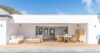 Outdoor dining terrace at a St Barts villa rental with panoramic sea views and evening glow.