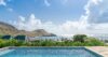 Elegant villa bedroom in St Barts with soft linens, ocean breeze, and serene Caribbean views.
