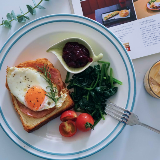 Breakfast plate with egg toast and greens.