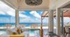 Bright living room opening to pool terrace with panoramic ocean views at a St Barts villa rental.