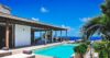 Villa with turquoise pool, shaded terrace, and ocean views at St Barts private villa rental.