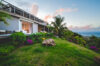 Villa with tropical garden, ocean view, and outdoor seating at St Barts villa rental.
