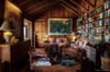 Cozy library lounge in St Barts villa with bookshelves and wood interiors.