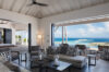 Spacious living room in St Barts villa with open terrace and sea views.