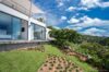 Contemporary St Barts villa with landscaped garden, floor-to-ceiling windows, and hillside island views.