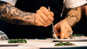 Private chef artfully plating gourmet cuisine at a luxury villa in St. Barts