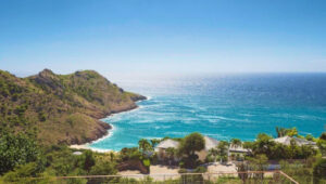 Ocean view from a villa in Gouverneur, St. Barts, overlooking lush hills and turquoise waters.