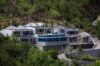 Aerial view of hillside villa with infinity pool and ocean backdrop in St Barths luxury rentals