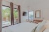 Bright bedroom with tropical views and pool access at Villa Amancaya, a private villa rental in St Barts.