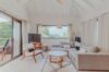 Contemporary living room at Villa Armancaya featuring soft neutral tones, wooden accents, and garden views in St Barts.”
