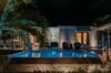 Villa Armancaya illuminated at night with glowing pool and tropical palms, a serene luxury villa in St Barts.