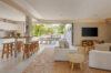 Open-plan living area with modern kitchen and outdoor dining terrace in a luxury St Barts villa rental.