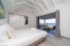 Bright bedroom with sea view and terrace access inside a contemporary St Barts villa rental.