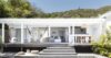 White open-air terrace with hammocks, lounge seating, and bar area at a private villa in St Barts surrounded by tropical greenery
