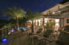 Night view of illuminated terrace with palm trees and poolside loungers at luxury villa rental in St Barths