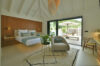 Contemporary bedroom with terrace access and warm wood accents at private villa rental in St Barths.