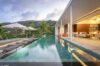 Evening view of infinity pool and open living area at contemporary luxury villa rental in St Barths.