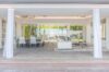 Open living and dining area with garden and pool views at a luxury St Barts villa rental.