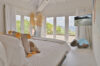 Bright bedroom with sea view and natural décor details at private villa rental in St Barthélemy
