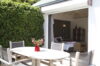 Private terrace with dining table and garden view leading to bedroom suite at Villa Plumbago, St Barts villa rental