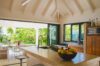 Open-air kitchen with island counter and tropical garden views at Villa Plumbago, St Barts villa rental.
