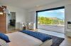 Serene bedroom with ocean-view terrace and minimalist design at Villa Plumbago, St Barts luxury villa rental.