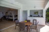 Outdoor dining area with pool bar and open bedroom access at Villa Plumbago, private villa rental in St Barts