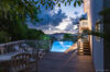 Night view of pool and terrace illuminated under tropical sky at Villa Plumbago, Colombier, luxury villas St Barts