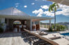 Sunlit terrace with loungers and covered dining area at Villa Plumbago, Colombier, St Barts luxury villas