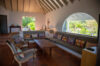 Bright living room with vaulted ceiling and tropical garden view at Villa Plumbago, Colombier, villa st barths.