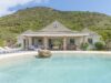 Serene St Barts villa with a lagoon-style pool set against lush green hills, offering relaxed island luxury.