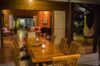 Candlelit outdoor dining area opening to a cozy living room and hammock terrace at a private villa rental in St Barts