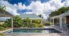 Private pool surrounded by tropical gardens and Caribbean-style pavilions at a luxury St Barts villa rental.