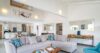 Bright open-plan living room with modern furnishings and high ceilings in a luxury St Barts villa rental