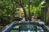 Private outdoor jacuzzi surrounded by tropical gardens at a luxury St Barts villa rental.