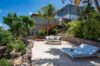 Private sandy terrace with sun loungers and palm trees below Villa Plumbago, st barts villa rental