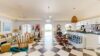 Bright open-plan living area in st barths villas with checkered floor, coastal décor, and ocean view