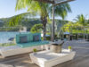 Private villa rentals st barts with ocean-view terrace, champagne setup, and palm trees.