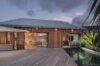 Elegant wooden terrace with evening light reflecting on pool at luxury villa st barths