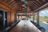 Spacious covered dining terrace with wooden beams and hillside views at st barts villa rental.